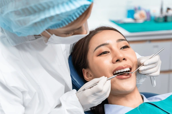 caucasian dentist examine tooth young 600nw 2250693847